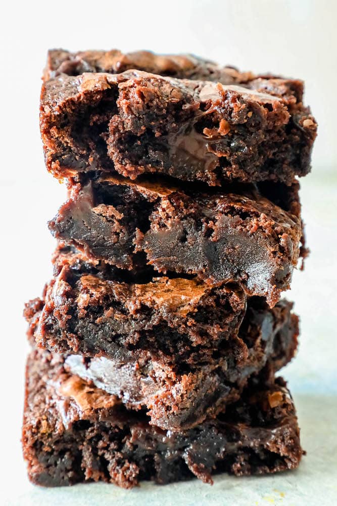 5 brownies stacked with gooey interiors