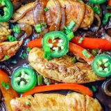 One-pot chicken fajitas cooked in a skillet with peppers, onions, and jalapenos.