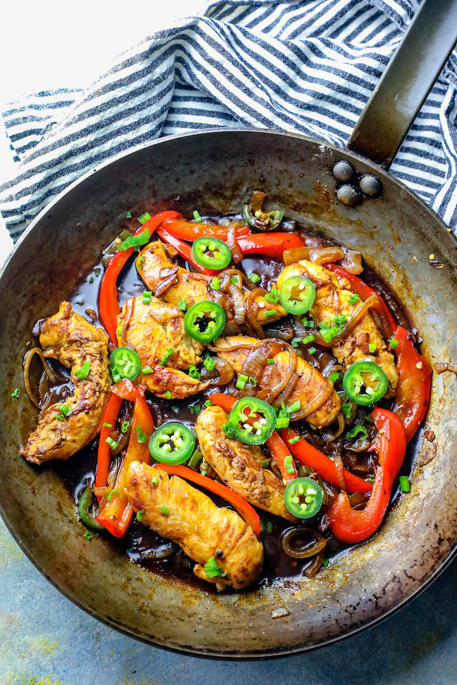 chicken, onions, peppers, and jalapenos in a pan together