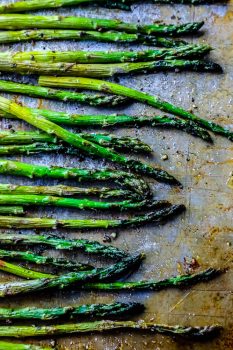 Roasted asparagus on a baking sheet.