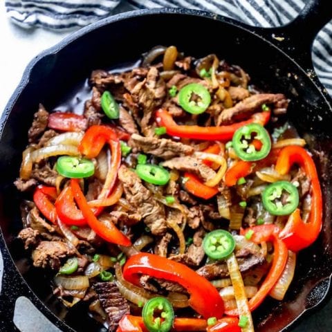 A one-pot skillet dish featuring beef, peppers, and onions.