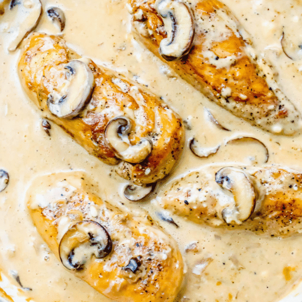 Chicken Stroganoff features tender chicken breasts and mushrooms in a creamy sauce, topped with sliced mushrooms—an easy 20 minute cream cheese chicken dinner shown in close-up.