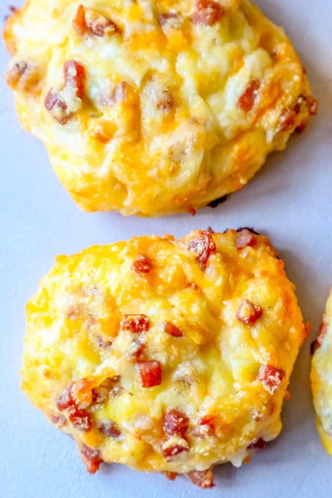 Closeup of the top of a baked keto ham and cheese roll. 