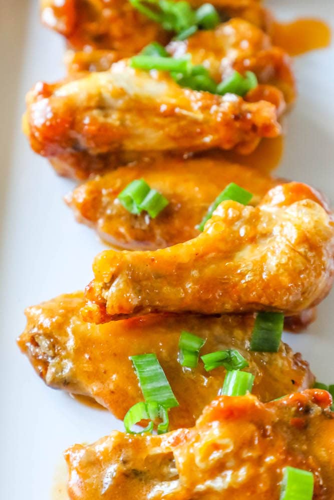 chicken wings in sauce on a plate