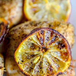 Grilled chicken with lemon slices served on a plate using air fryer for an easy and keto-friendly alternative to fried chicken.