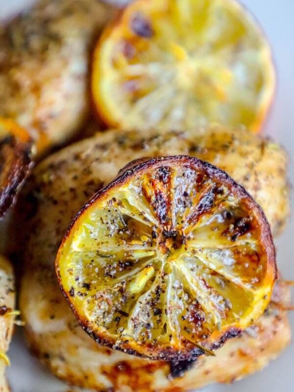 Grilled chicken with lemon slices served on a plate using air fryer for an easy and keto-friendly alternative to fried chicken.