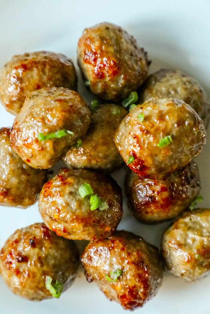 stack of meatballs with green onions on them