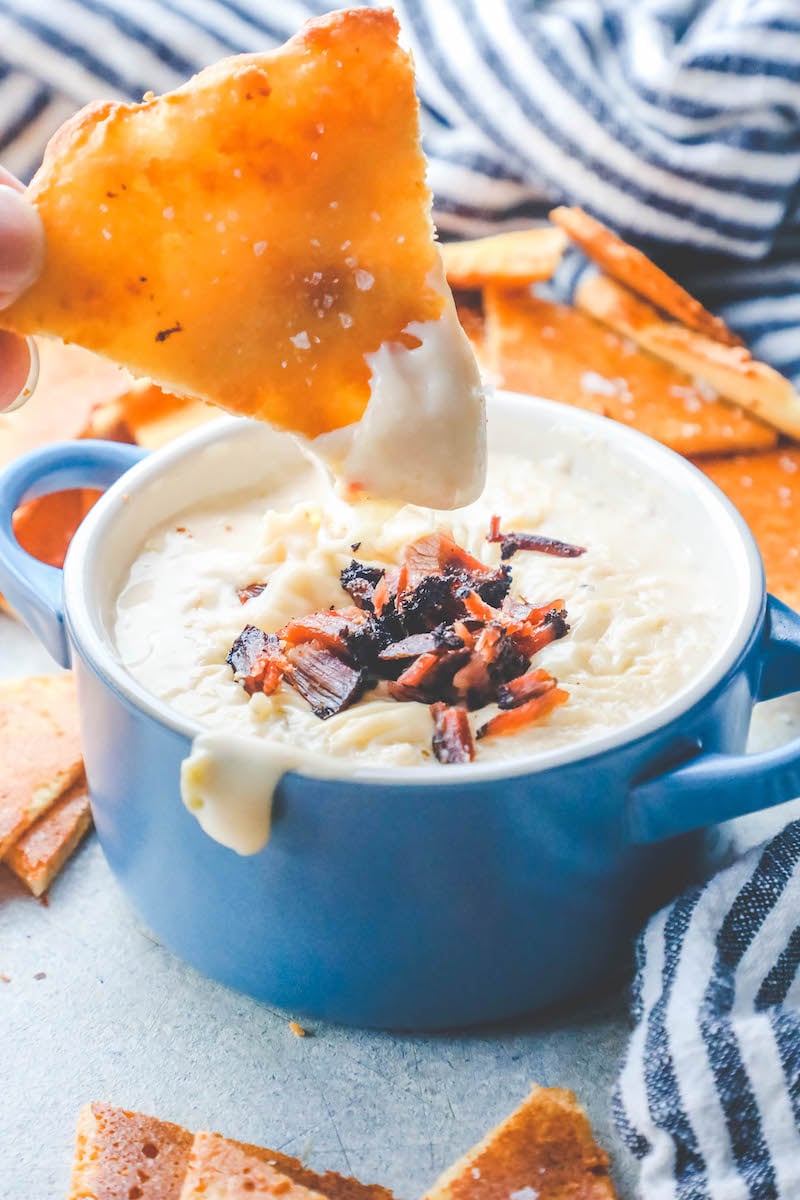 picture of hand dipping keto chip into dip