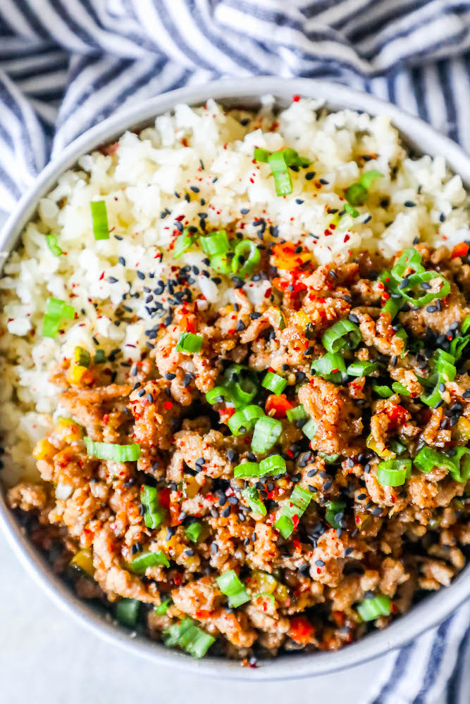 a bowl with rice, ground turkey, and green onions on it