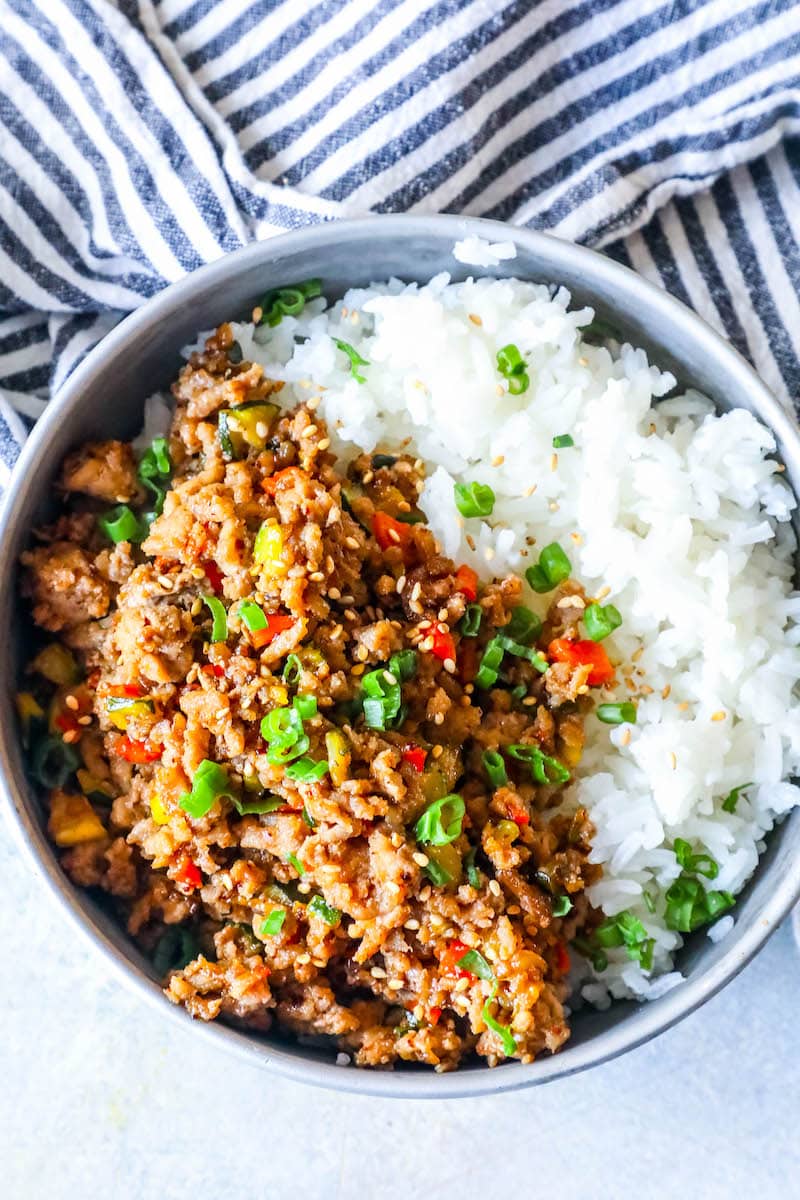 rice in a bowl with ground turkey, green onions, and red bell pepper