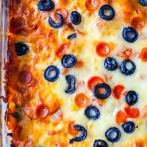 A cheesy low carb pizza casserole topped with olives.
