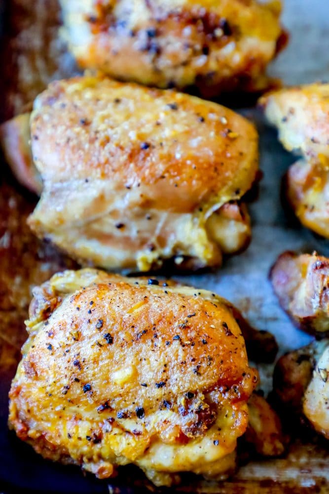 picture of baked chicken thighs on a baking sheet