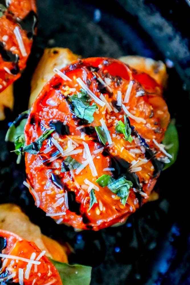 picture of tomato over chicken thigh topped with cilantro balsamic and parmesan 