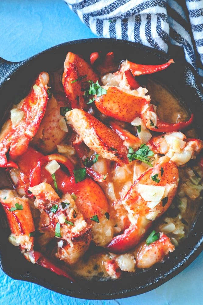 lobster in a skillet with butter and parsley