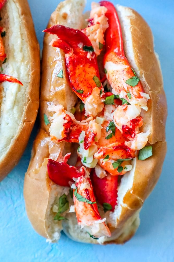 picture of naked garlic butter lobster roll in a bun on a table
