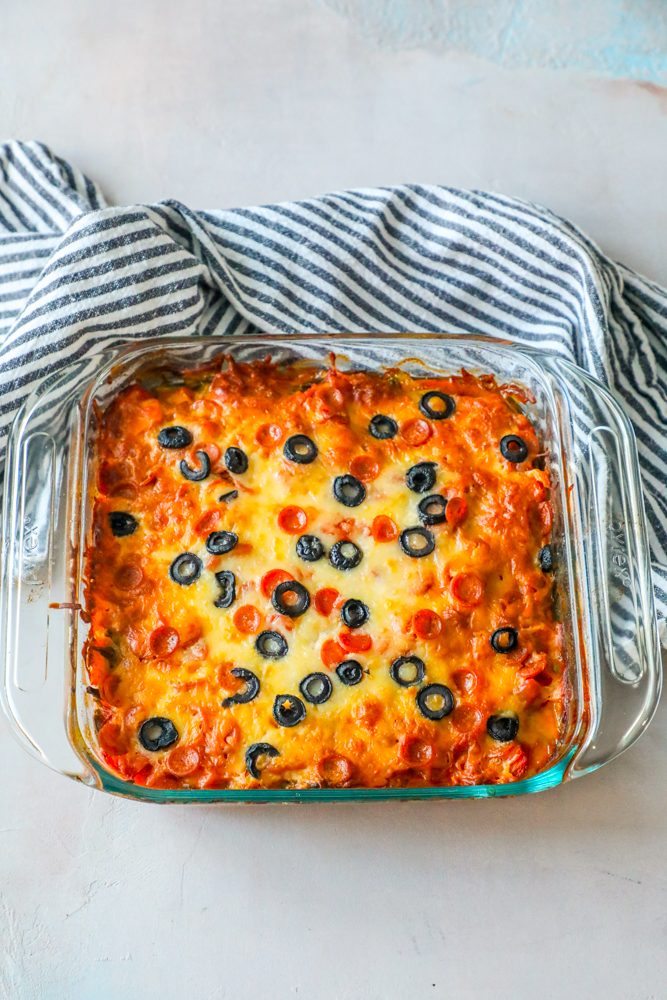 casserole with vegetables and melted cheese and black olives on top