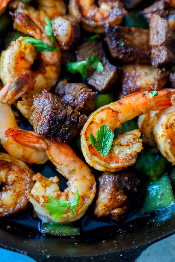 shrimp, steak, and spices, parsley all over it