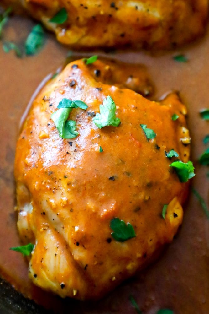 chicken with orange sauce and cilantro on it