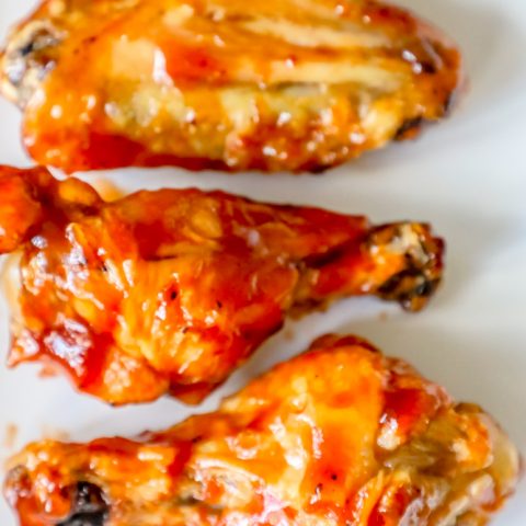 A delicious keto chicken wings recipe featuring the best baked BBQ wings ever, served on a white plate.