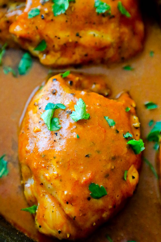 chicken with orange sauce and cilantro on it