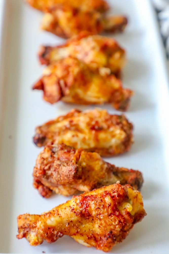 dry rub baked chicken wings on a white plate