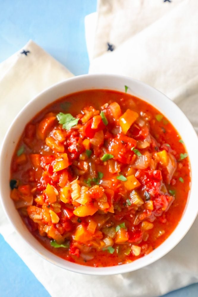 bowl of tomato sauce with onions, celery, and cilantro