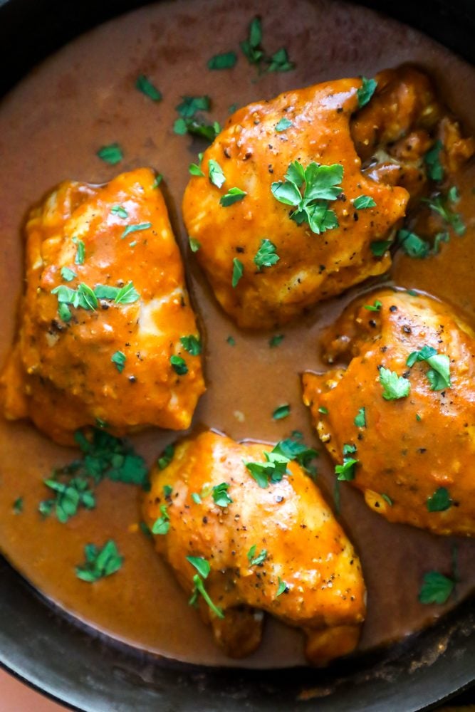 chicken with orange sauce and cilantro on it