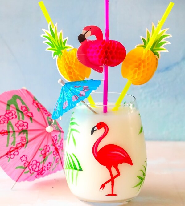 A pina colada with flamingos and pineapples.