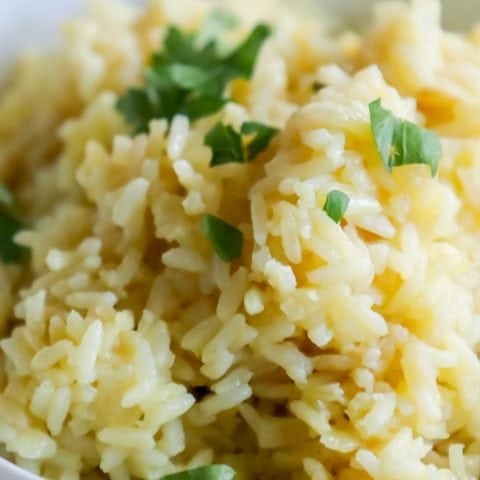 A bowl of rice pilaf with parsley.