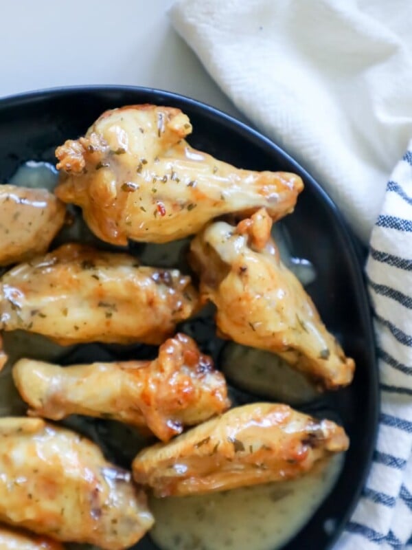 Easy baked ranch chicken wings with sauce on a plate.