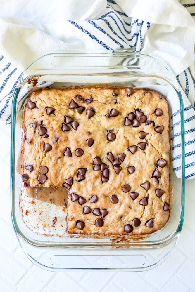 banana chocolate chip bread in a square glass pan with one bar missing.