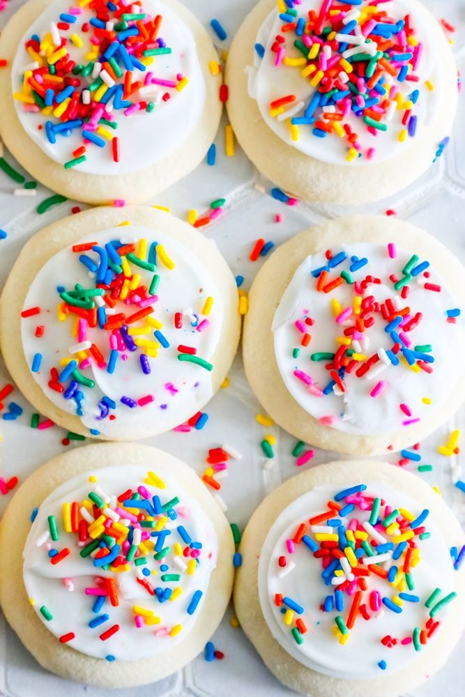 picture of four iced cookies with sprinkles