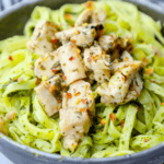 A bowl of pasta with chicken and chimichurri pesto.