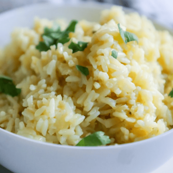 A bowl of creamy risotto, an easy rice side dish, garnished with fresh herbs.
