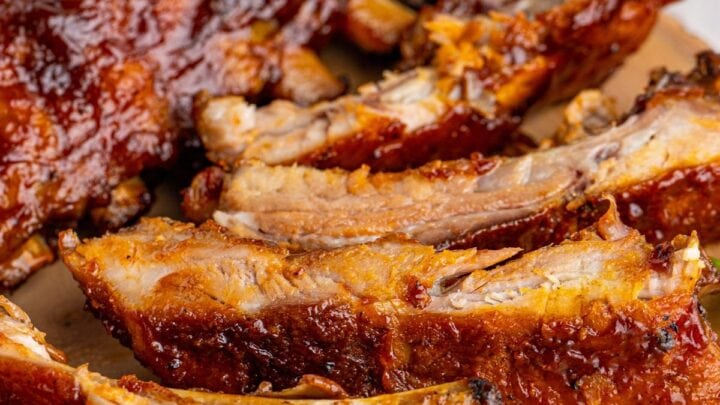 picture of ribs slathered in sauce on a wood platter