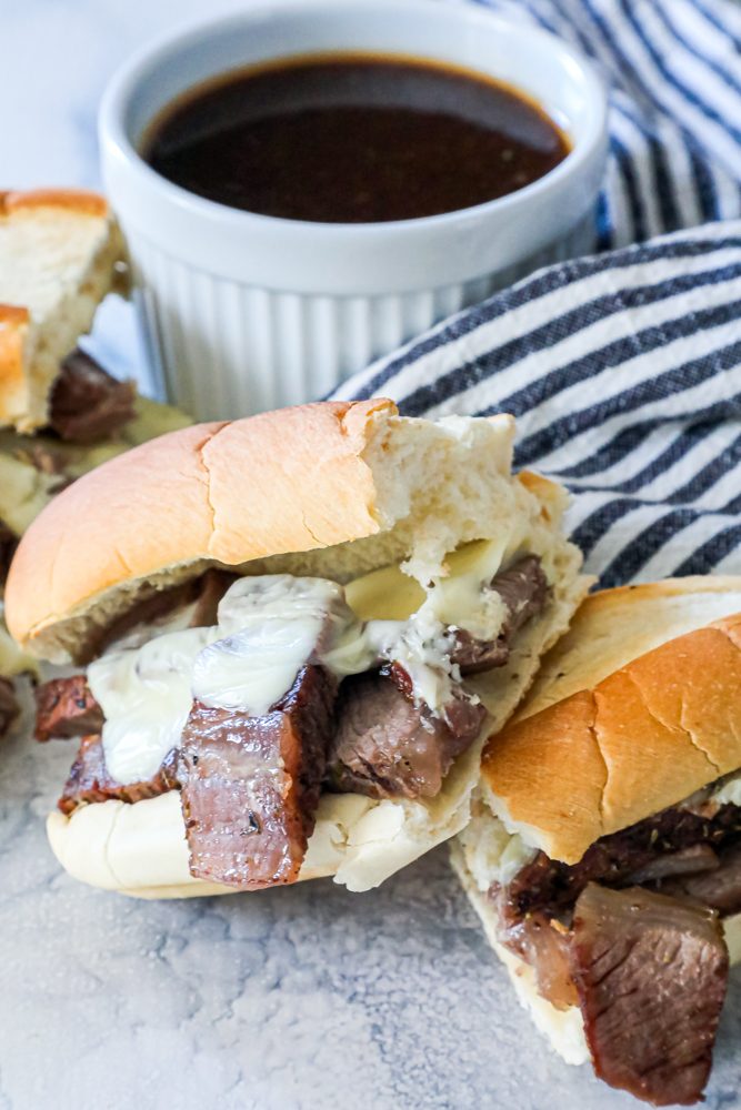 French dip sandwiches in front of au jus dip picture