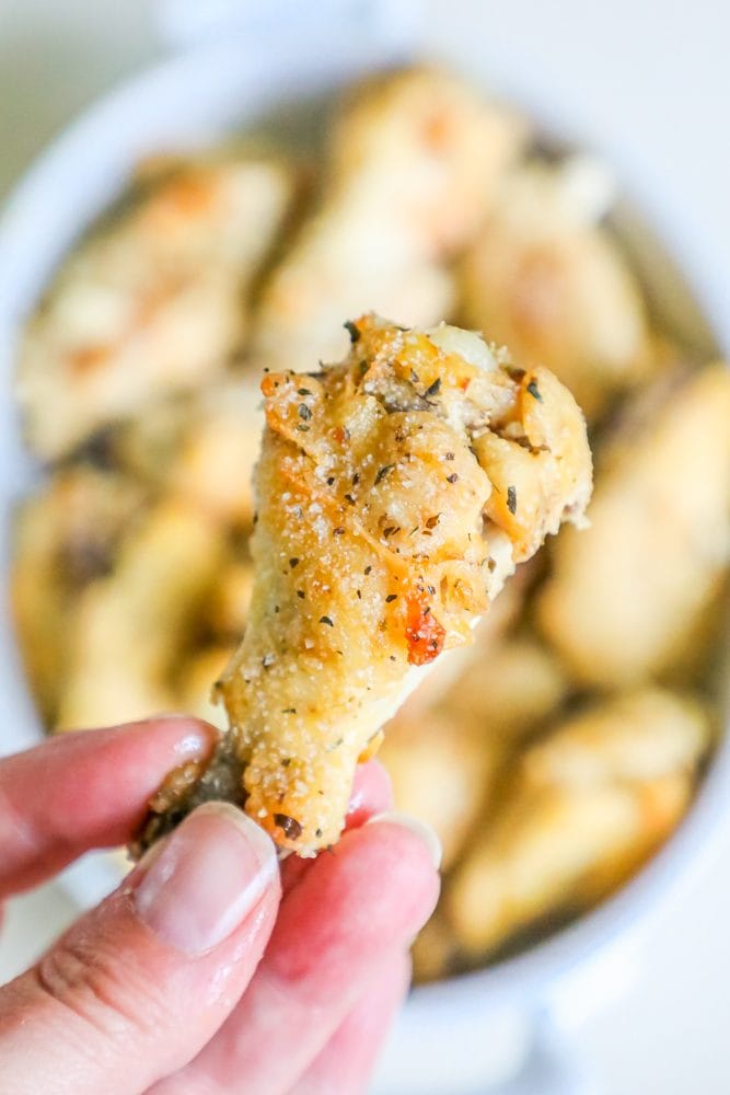 picture of parmesan chicken wings in a hand