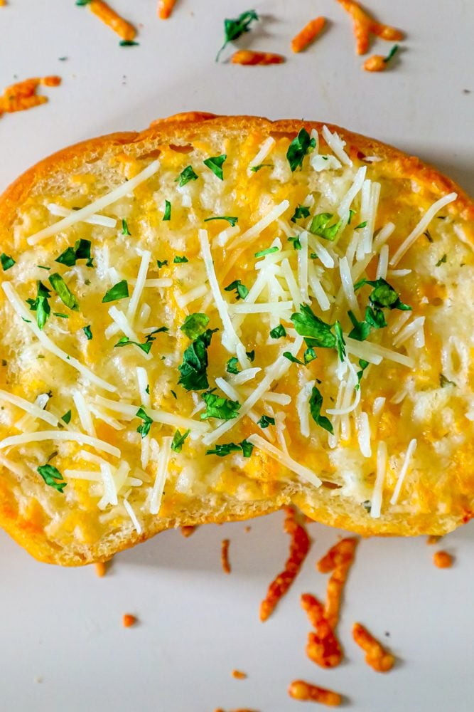 slice of toast with cheese and cilantro on top 