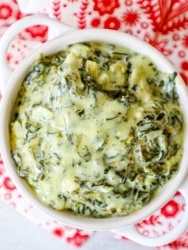 Creamed spinach dip served in a white bowl.