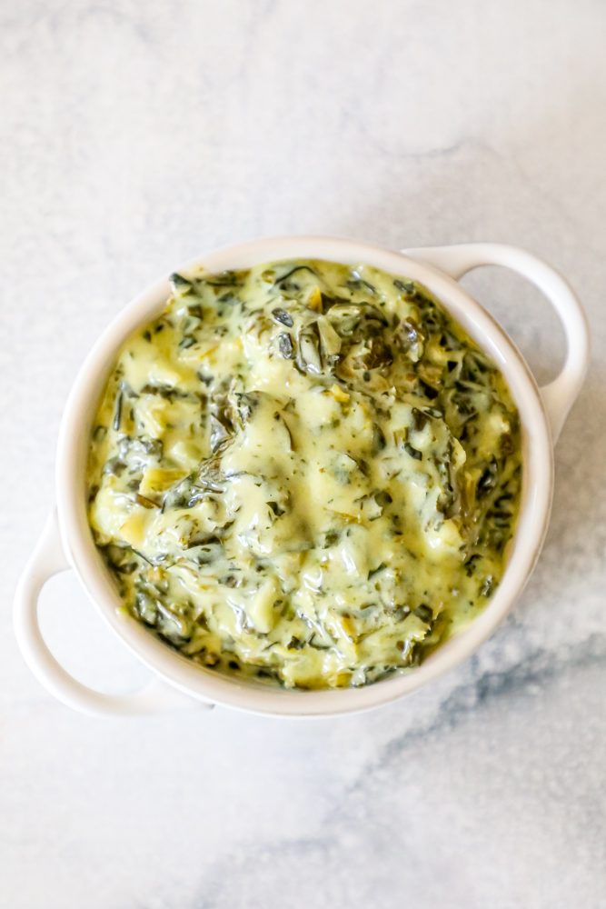 creamed green spinach in a white bowl