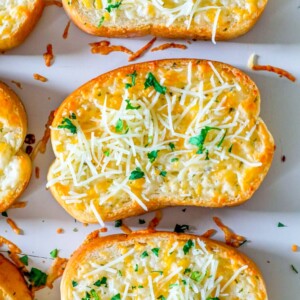 Cheesy bread topped with parsley.