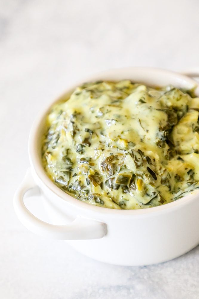 creamed green spinach in a white bowl