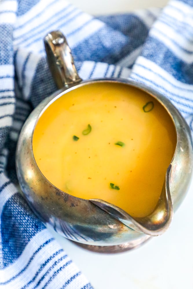 A bowl of soup with a blue and white towel.