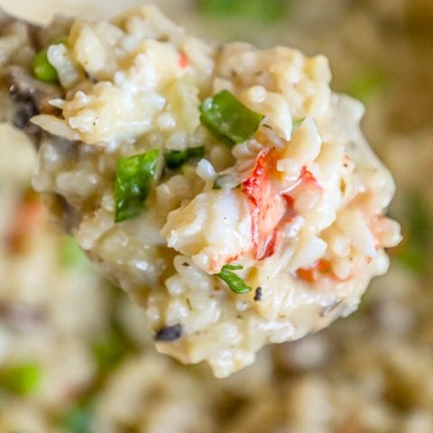 A spoon full of easy lobster risotto with shrimp and vegetables.