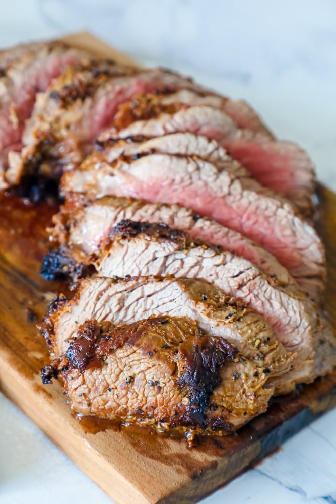 tri tip steak sliced on a board