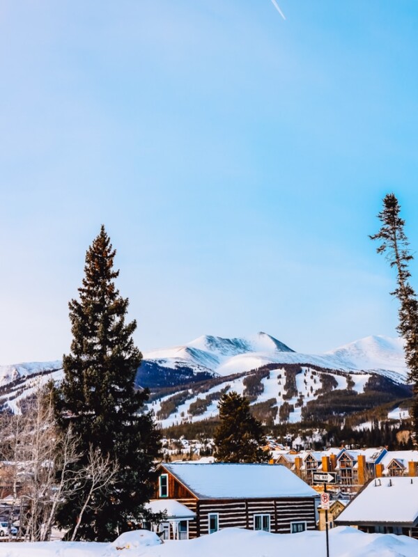 A view of The Ranahan By Welk Resorts ski resort in Breckenridge, Colorado, with snow covered trees and mountains in the background.