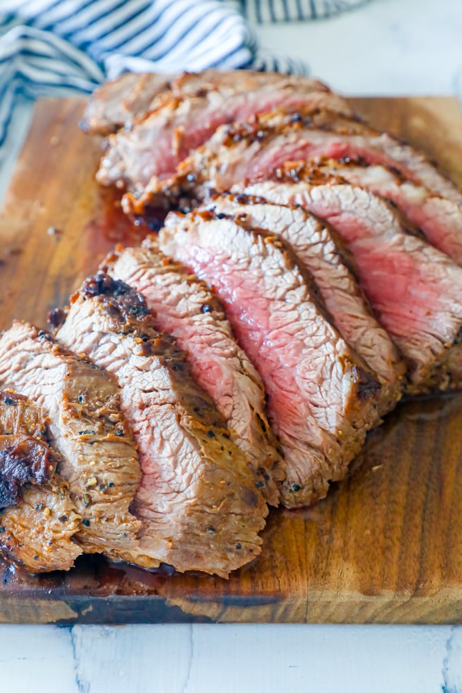 tri tip steak sliced on a board