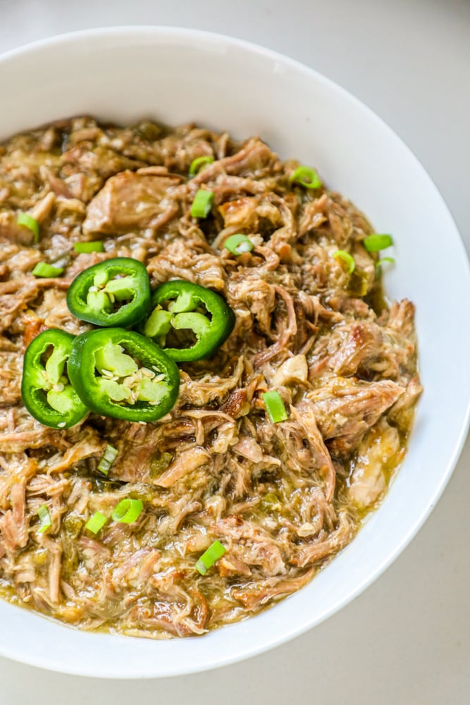 bowl of shredded pork with green chiles and jalapenos on it