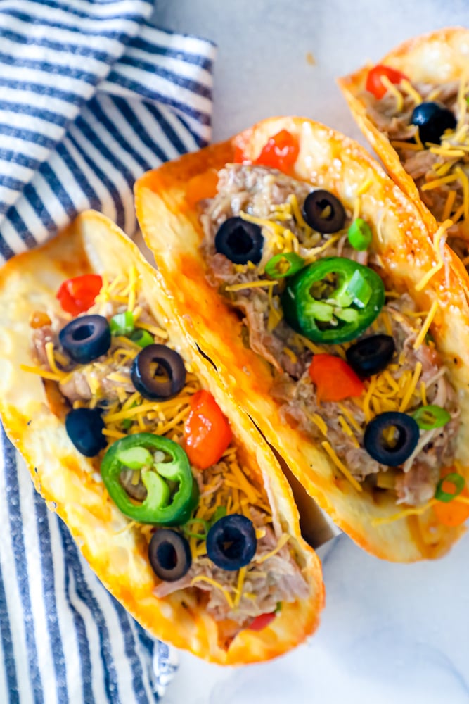 cheese shells with shredded pork with jalapenos and black olives