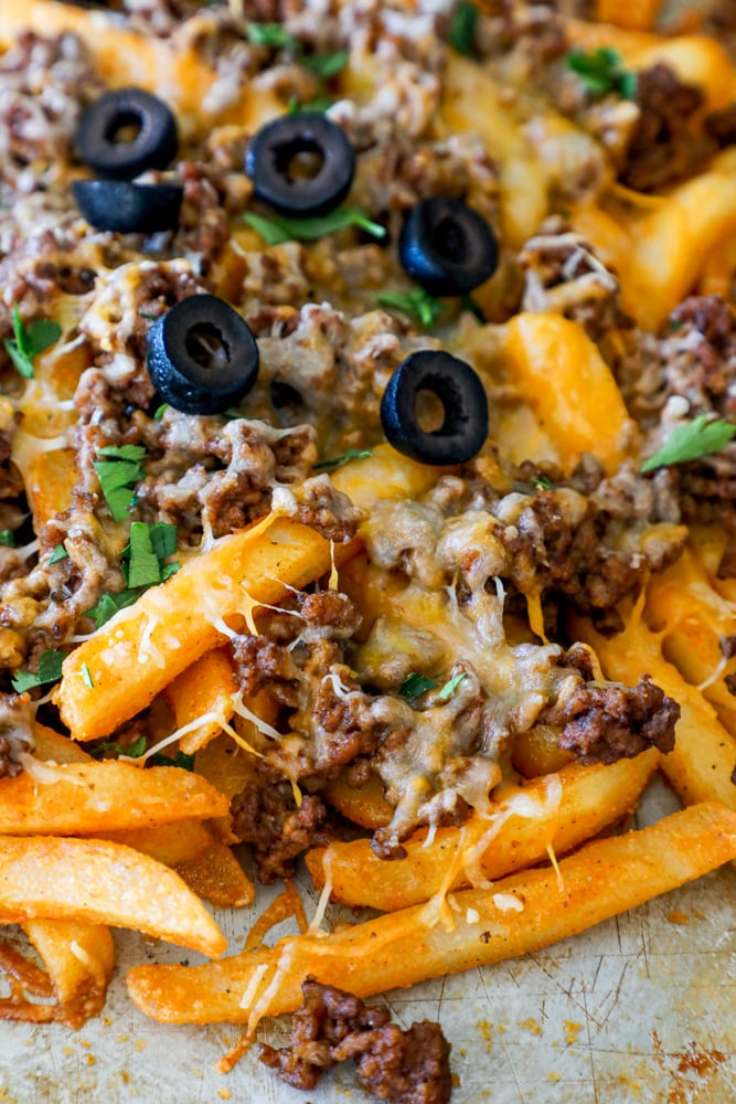 fries on a sheet pan with ground beef, cheese, and black olives